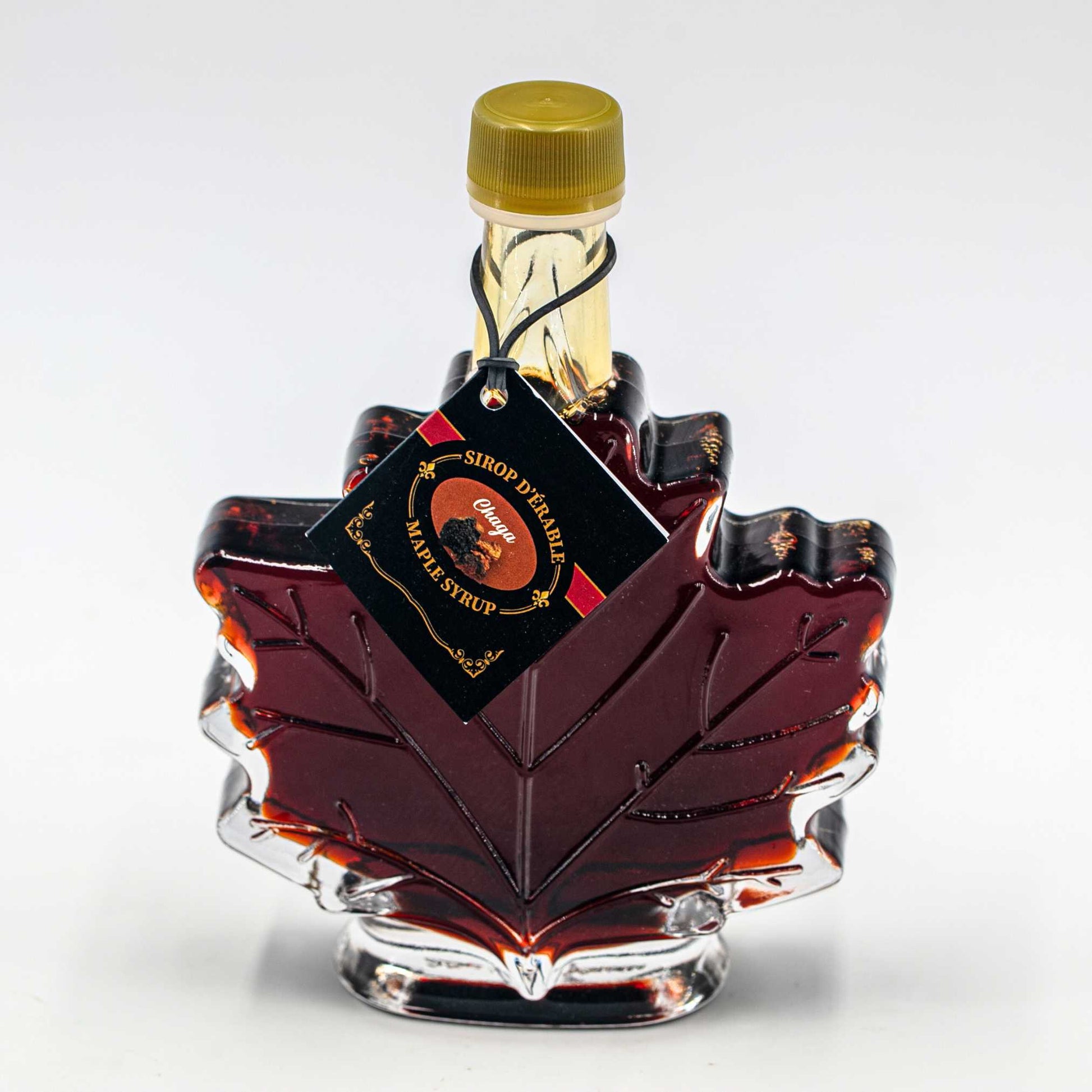 Infused maple syrup chaga Nature Artisan 100ml in a maple leaf glass bottle.