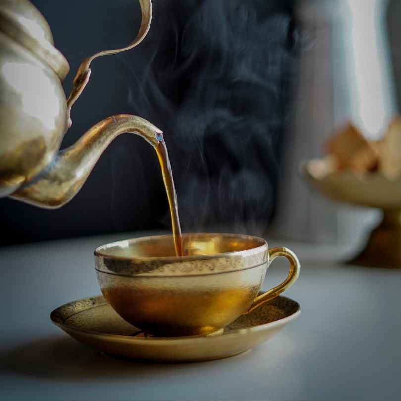 A warm infused herbal tea poured into a cup